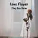 A wilted rose in a clear glass vase against soft window light, the cover art for Lone Flower