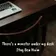 A laptop on a dark wooden desk with a chair pulled up to it, the cover art for There's a Monster Under My Desk